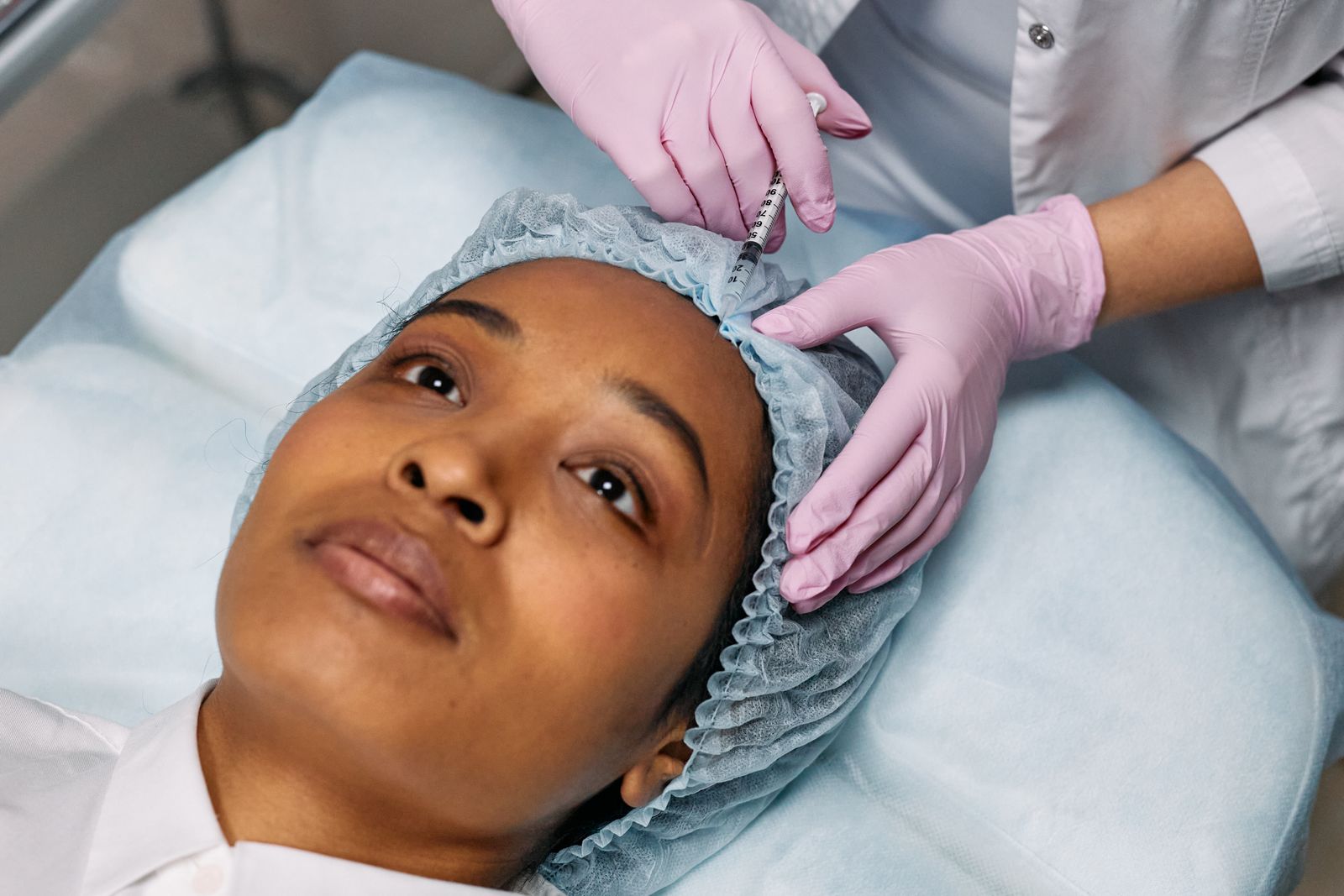 A woman receiving a facial treatment